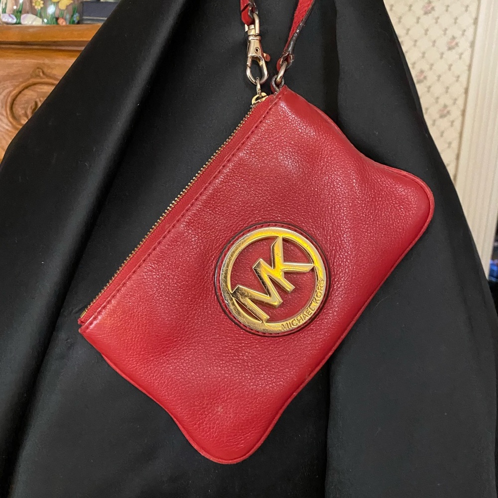 Small red Micheal Kors wristlet with zipper